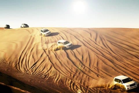 Dubai Desert Safari With BBQ Dinner, Camel Ride, Belly Dancing and sandboarding