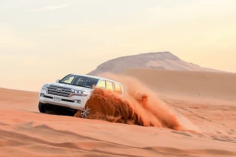 Dubai Camel Riding Sandboarding and Dune Bashing Experience