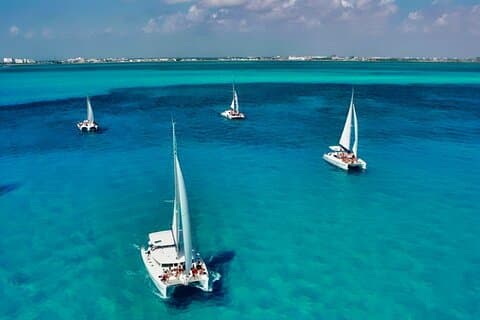 Crucero de día completo en catamarán a Isla Mujeres con snorkel y club de playa