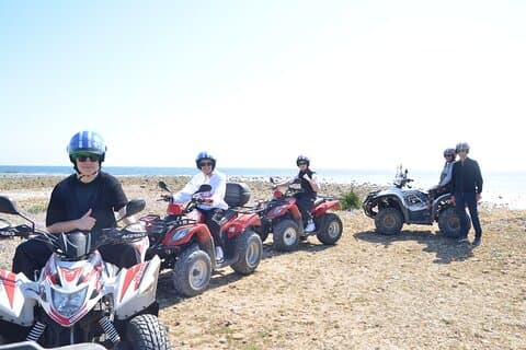 Quad tour between vineyards and the sea with a glass of wine.