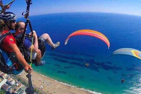 Parapendio tandem con pilota autorizzato da lato