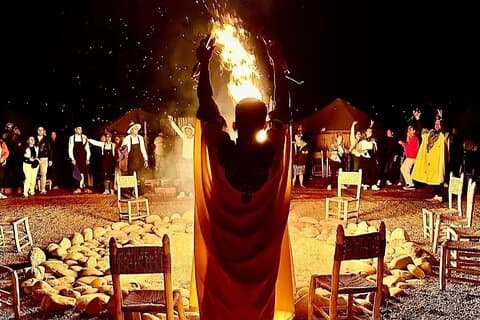 luxury diner with fire show with camel sunset in Agafay desert