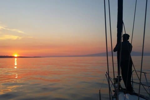 Aperitif on a sailing boat at sunset in Catania
