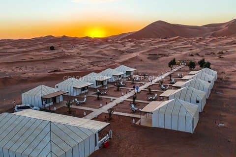 Overnight stay in luxury desert camp camel ride &sandboarding
